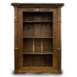 A LARGE HEAVY HARDWOOD BOOKCASE constructed from a carved door surround with pilaster columns, 170cm