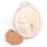 A MOULDED PLASTER FEMALE PORTRAIT RELIEF 42cm x 30cm and a terracotta face mask 15cm x 22cm (2)