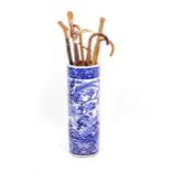 A BLUE AND WHITE CHINESE CYLINDRICAL STICK STAND 64cm high overall, decorated with fanciful bird