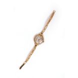 AN EARLY 20TH CENTURY LADIES ROLEX WRIST WATCH with a 9 carat gold case and a rolled gold strap, the