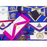 A GROUP OF MASONIC REGALIA to include aprons, medals, books etc and three silver Masonic medals