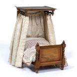 A 19TH CENTURY WALNUT MINIATURE TESTER BED 34cm long x 24cm wide x 42cm high