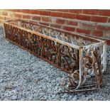 A WHITE PAINTED WROUGHT IRON PLANTER with scrolling decoration, 176cm long x 26cm deep x 26cm high