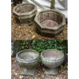 A PAIR OF COMPOSITE STONE OCTAGONAL PLANTERS each 54cm diameter x 29cm in height, a further pair