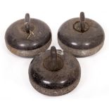 A SET OF THREE 19TH CENTURY GRANITE CURLING STONES with bronze and ebony handles, each 25cm diameter