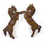 A PAIR OF MIDDLE EASTERN POLYCHROME PAINTED SCULPTURAL HORSES each in a rearing posture, each