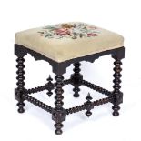 A 19TH CENTURY STOOL with needlepoint upholstered seat and bobbin turned supports, 46cm wide x