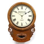 A LATE VICTORIAN OAK DROP DIAL WALL CLOCK with carved foliate decoration, the dial painted with