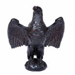 A CARVED WOODEN EAGLE SCULPTURE 59cm wide x 68cm high