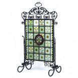 A LATE VICTORIAN ARTS AND CRAFTS WROUGHT IRON FIRE SCREEN with scroll decoration to the frame and