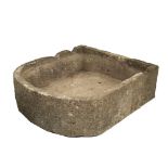 A LARGE CARVED LIMESTONE TROUGH with bowed front and notches cut to the back, approximately 92cm