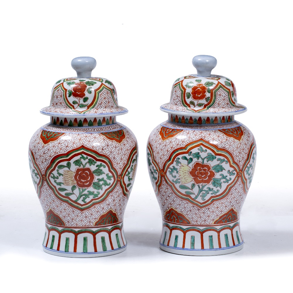 A PAIR OF PORCELAIN LIDDED VASES of baluster form, each with red and green foliate decoration,