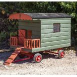 A GREEN AND RED PAINTED BANTAM CHICKEN HOUSE in the form of a gypsy caravan, on wheels and with pull