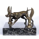 A DESK TOP SCULPTURE in the form of a bronze hound, with eagle finials to either side and all on a