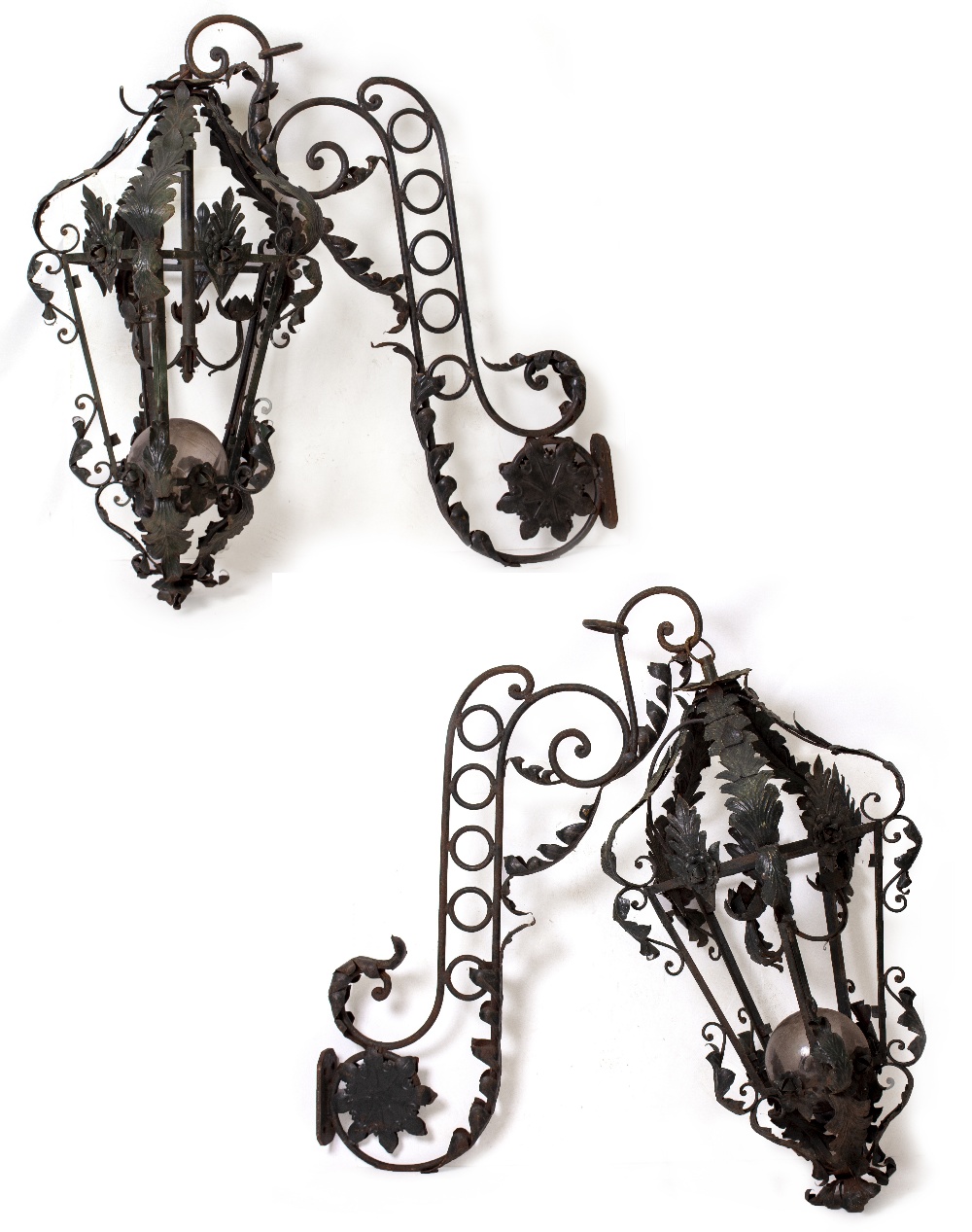 A PAIR OF LARGE WROUGHT IRON GREEN PAINTED LANTERNS with moulded leaf designs and each supported