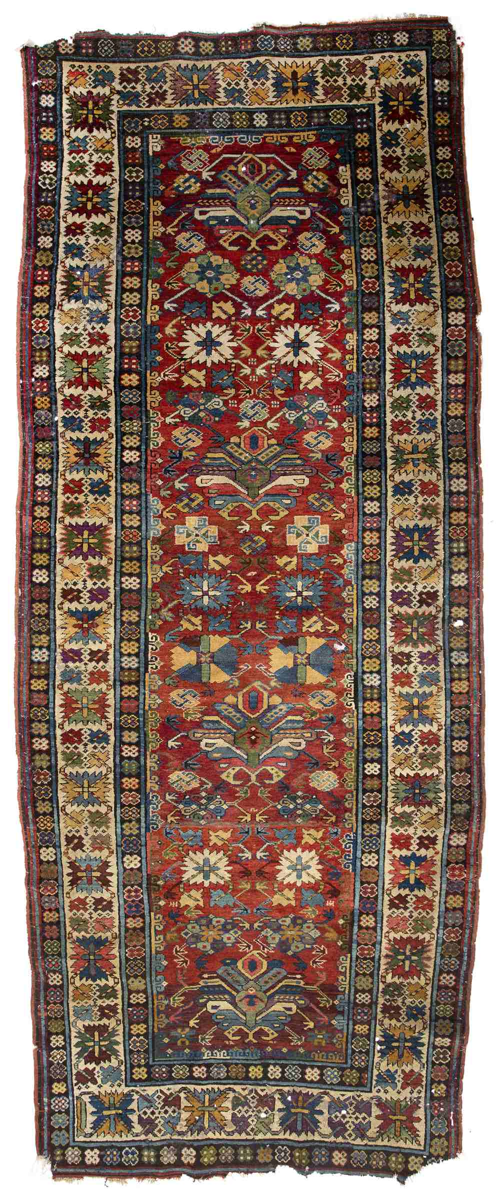 AN ANTIQUE CAUCASIAN POLYCHROME RUG with a multiple banded border and stylised foliate decoration,