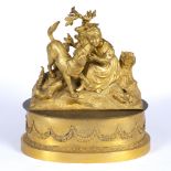 A GILT ORMOLU SCULPTURE of a young girl, with her attentive dog, 24cm wide x 21cm high together with