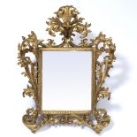 AN ANTIQUE ITALIAN CARVED GILTWOOD ROCOCO WALL MIRROR the frame with later glass, 52cm wide x 66cm