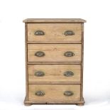 A SMALL PINE CHEST OF FOUR LONG DRAWERS with brass handles and raised on squat bun feet, 58cm wide x