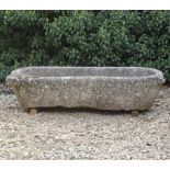 AN ANTIQUE MARBLE TROUGH with rounded ends, 144cm long x 60cm deep x 32cm high