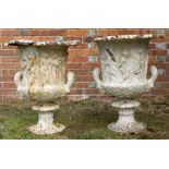 A PAIR OF VICTORIAN WHITE PAINTED CAST IRON GARDEN URNS of campana form with classical decoration,