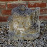 AN OLD CARVED STONE SCULPTURE depicting a Scottish bagpipe player, 30cm wide x 33cm high