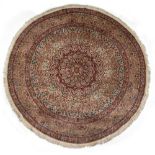 AN ORIENTAL CIRCULAR SILK RUG with radiating geometric flower decorations, 200cm diameter