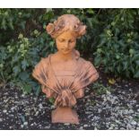 A CAST RECONSTITUTED TERRACOTTA ART NOUVEAU STYLE BUST of a young girl with flowers in her hair,