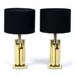 A PAIR OF MODERNIST TABLE LAMPS in the form of a cluster of columns, each on a circular base and
