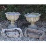 A PAIR OF COMPOSITE STONE PLANTERS with acanthus leaf scrolling design, 48cm diameter x 40cm in