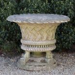 A LARGE COMPOSITE STONE PLANTER with a flared rim, scalloped edge of woven basket design with four