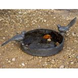 A SMALL SHALLOW LEAD BIRD BATH 30cm diameter with two cast lead birds perched on either side