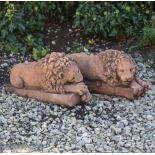 A PAIR OF CAST RECONSTITUTED STONE TERRACOTTA COLOURED RECUMBENT LIONS after Canova, 44cm long