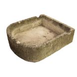 A LARGE CARVED LIMESTONE TROUGH with bowed front and notches cut to the back, approximately 92cm