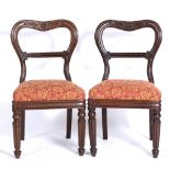 A SET OF SIX EARLY 19TH CENTURY MAHOGANY BALLOON BACK DINING CHAIRS the cresting rails carved with