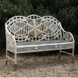 A WHITE PAINTED CAST IRON GARDEN BENCH with pierced decoration and a wooden slatted seat, 122cm wide