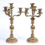 A PAIR OF ORMOLU THREE BRANCH FOUR LIGHT CANDELABRA of classical form, cast with acanthus leaves and