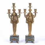 A PAIR OF FRENCH EMPIRE STYLE GILT METAL THREE BRANCH CANDELABRA of figural form, with square