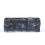 A RECTANGULAR LEAD PLANTER OR TROUGH decorated with swags and a lion, 73cm wide x 22cm deep x 25cm