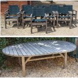 A LARGE TEAK GARDEN TABLE with rounded ends, 226cm x 155cm together with a set of ten blue and green