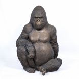 A LARGE COMPOSITE SCULPTURE of a seated gorilla, 82cm wide x 116cm high