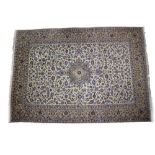 A KASHAM CREAM GROUND HAND KNOTTED WOOLEN CARPET with a banded border and geometric stylised foliate