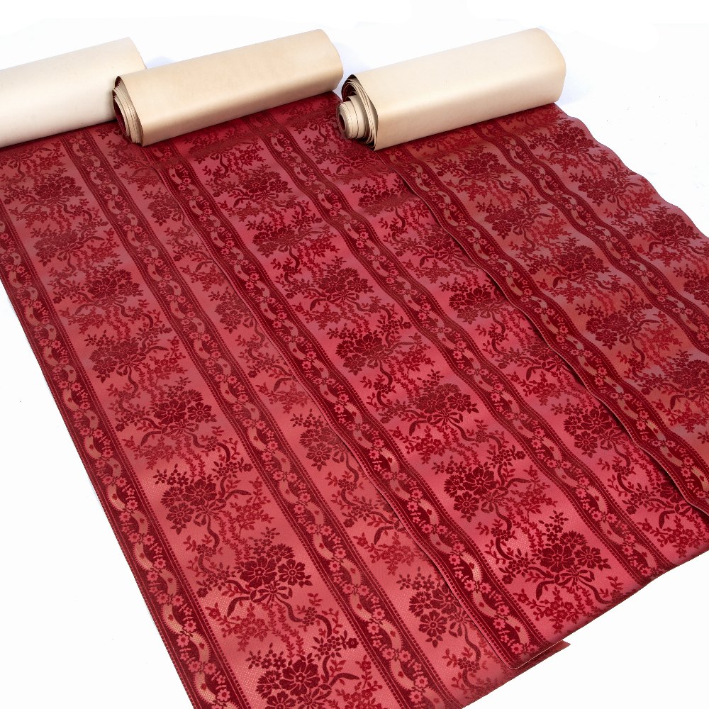 THREE BOXED ROLLS OF RED FLOCK WALL PAPER