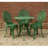 A GREEN PAINTED PIERCED ALUMINIUM GARDEN TABLE and three matching chairs, the table 67cm diameter