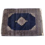 A PERSIAN STYLE BLUE GROUND RUG with a geometric banded border, signed to one end, 180cm x 48.5cm