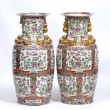 A PAIR OF CHINESE LARGE FAMILLE ROSE FLOOR VASES of baluster form with flaring rims, 40cm diameter x