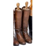 A PAIR OF BROWN LEATHER RIDING BOOTS with shoe trees, 29.5cm long toe to heel