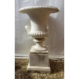 A WEATHERED MARBLE CAMPANA URN the flaring rim with egg and dart decoration, scrolling handles,