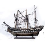 AN ANTIQUE MODEL DEPICTING A THREE MASTED SHIP OF THE LINE with two rows of gun ports and with