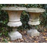 A PAIR OF RECONSTITUTED STONE GARDEN URNS of campana form, 46cm diameter x 60cm high